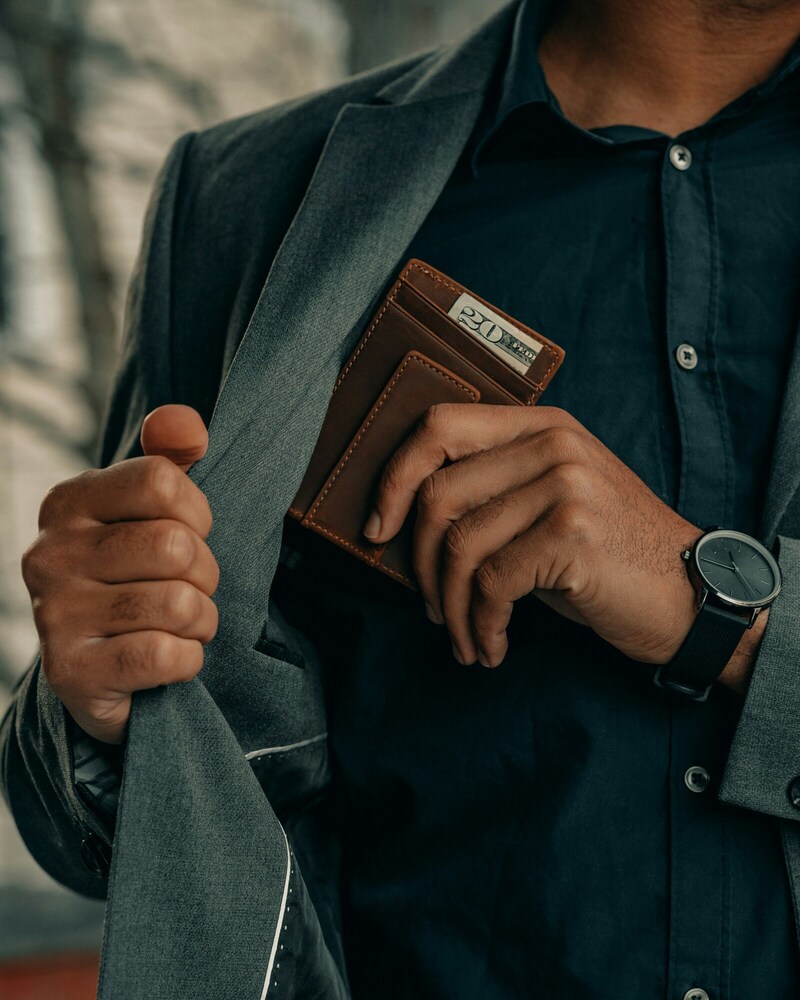 Man putting credit card in his suite pocket