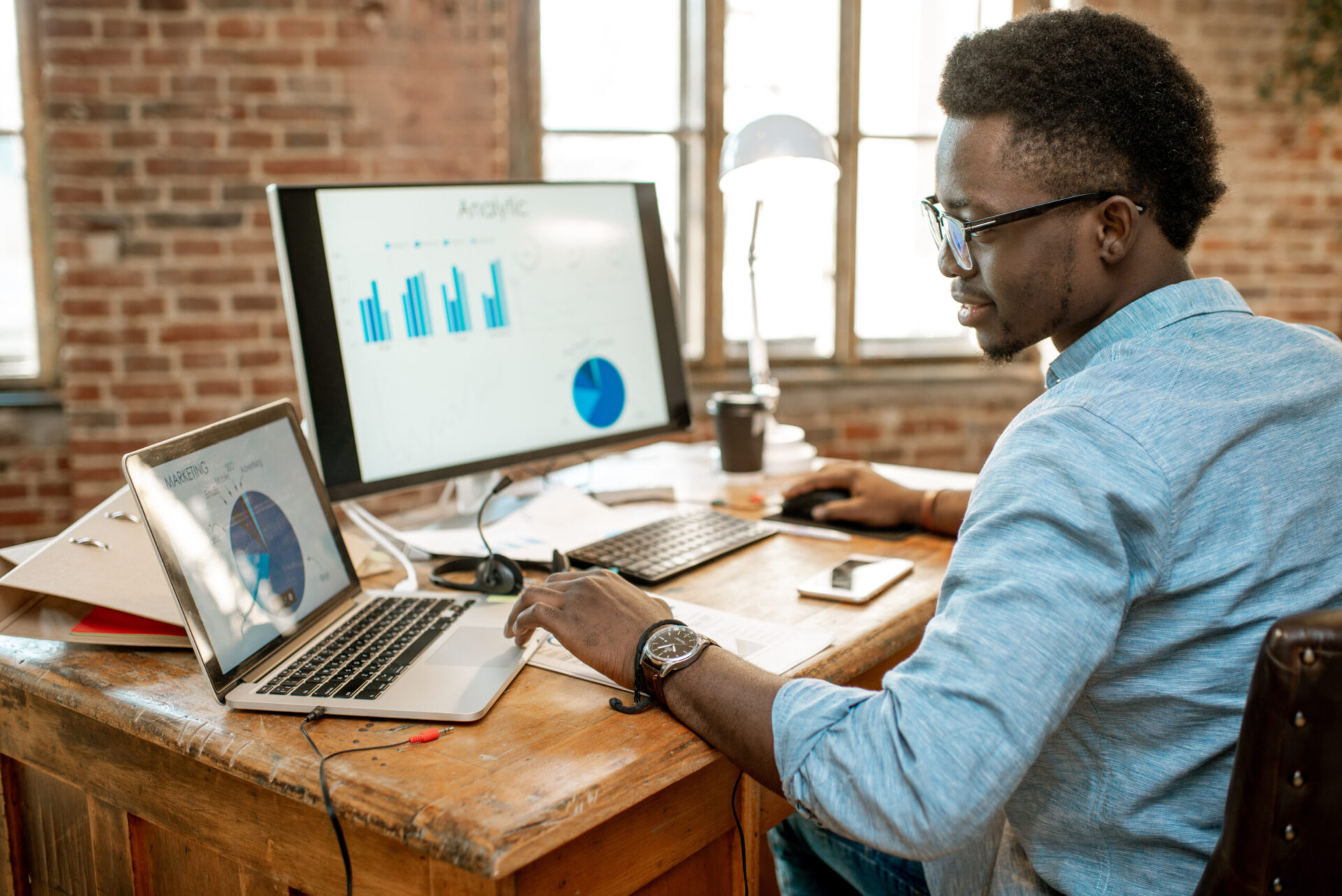 Man sitting at a computer reviewing data as a service (DaaS) information.