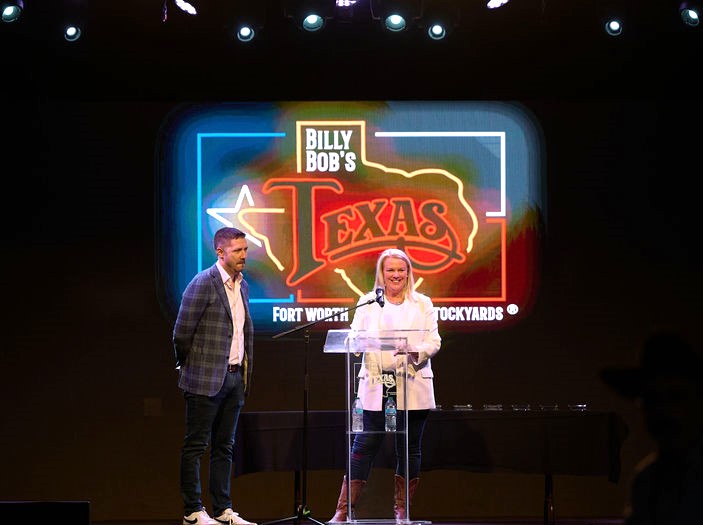 Trintech employees Jesse LaJoye and Clodagh Swennumson on stage at Billy Bob's Honkytonk